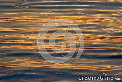 Rippling water with sunset colours reflecting background Stock Photo