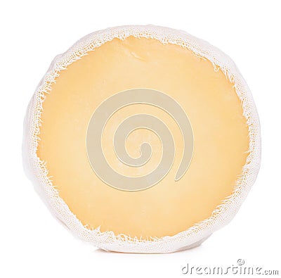 Soft round cheese wrapped in cheesecloth stand on its edge isolated Stock Photo