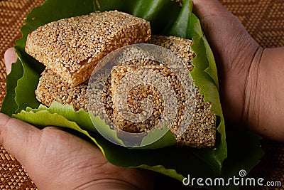 Soft sesame dessert in lotus leaf and there is a hand holding Thai desserts Stock Photo