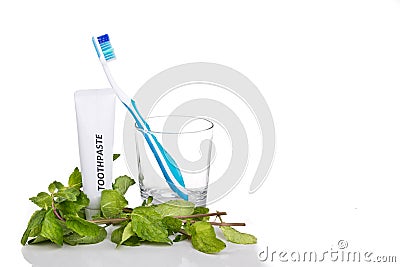 Soft tapered bristle toothbrush with toothpaste and mint leafs Stock Photo