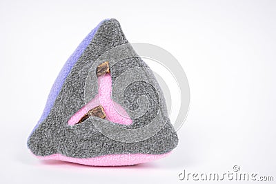 Soft textile washable snuffle toy in shape of pyramid with dried treats hidden in pockets for dogs nose work, white Stock Photo