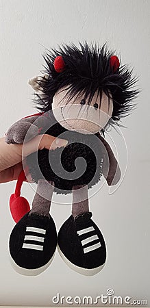 Soft toy designed as boy devil on white background Stock Photo