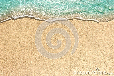 Soft waves with foam of blue ocean on the sandy beach Stock Photo