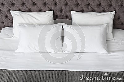 Soft white pillows on comfortable bed Stock Photo