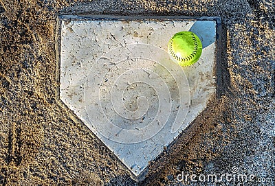 Softball on home plate Stock Photo