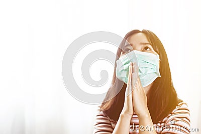 Softfocus of Young woman in hygienic mask are praying Stock Photo