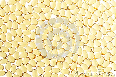 Softgels of Omega-3 on isolated background. Texture of yellow capsules on isolated white background. Medical medicament of Stock Photo