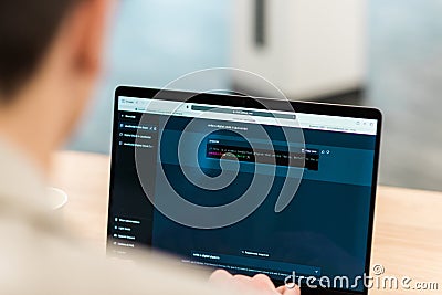 Software developer generating code in an AI chat Editorial Stock Photo