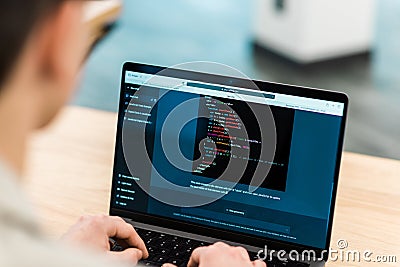 Software developer generating code in an AI chat Editorial Stock Photo