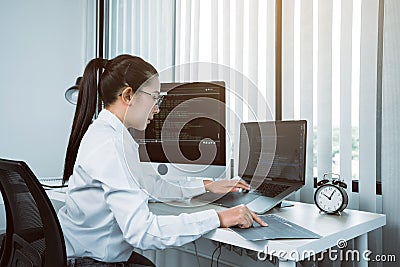 Software developers are analyzing about the code written into the program on the computer in office room Stock Photo