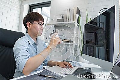 Software development concept, Male programmer checking website programming and drinking coffee Stock Photo