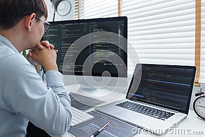 Software development concept, Male programmer read data code to thoughtful about developing website Stock Photo