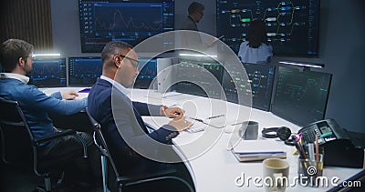 Software programmer sits in front of computer with blockchain network Stock Photo