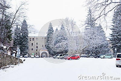 SOFÃA, BULGARIA - 13 DECEMBER 2017: View of the car park in front of the entrance to the snowy Rila Monastery. Editorial Stock Photo