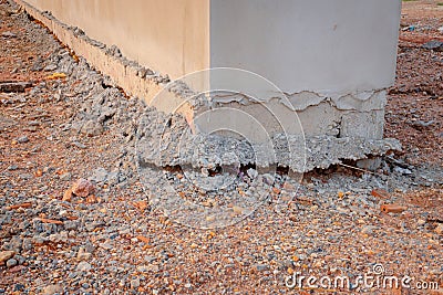 The soil collapsed on the side of the building wall. The ground compaction is not tight enough to cause the building to collapse c Stock Photo