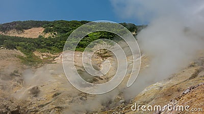 The soil on the hillside is covered with sulfur deposits. Stock Photo