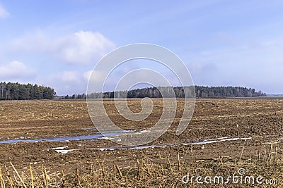 the soil prepared for sowing in the field at the end of winter Stock Photo