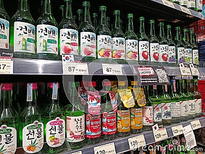 Sojub fruit liqueur, packaged in green glass bottles, is available on shelves in supermarkets. Editorial Stock Photo
