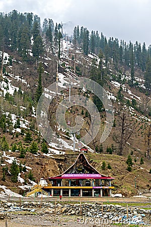 Solang, Himachal Pradesh, India-April 16th, 2015: Colorful entrance building of ski club and rope-way starting location with snow Editorial Stock Photo