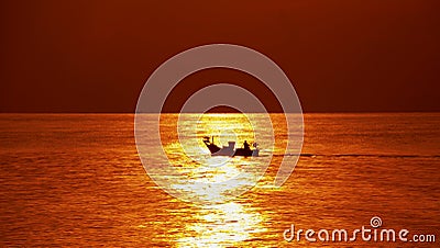 boat ran over the surface of the sea at sunrise. silhouette of small boat Stock Photo