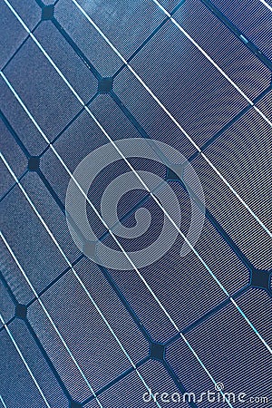 A solar cell pattern close up. Green energy and sustainable electricity resource concept. Solar panels blue background. Stock Photo