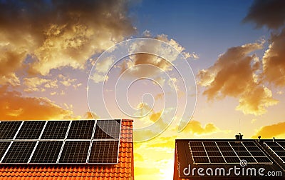 Solar energy panel on the roof of the house in the background sunset sky. Stock Photo