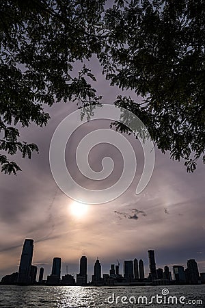 Natural Framed View of a Solar Halo over Jersey City Skyline - Manhattan, New York City Stock Photo