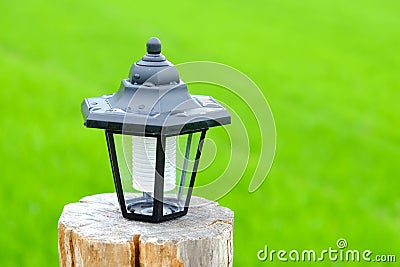 Solar lamp black install on a timber. Stock Photo