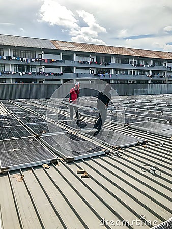 Solar panel technician and engineer working on installing solar panel. Renewable energy Editorial Stock Photo