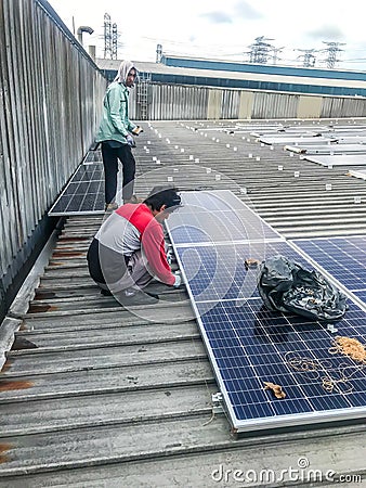 Solar panel technician and engineer working on installing solar panel. Renewable energy Editorial Stock Photo