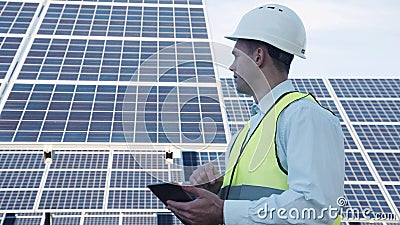 Solar panel technician using tablet near array Stock Photo