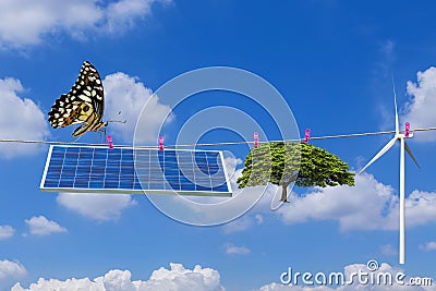 Solar panel and wind turbine and tree hanging on clothes line with butterfly Stock Photo