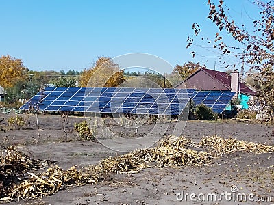 solar panels on the field near the house Stock Photo