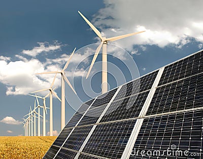 Solar panels in front of wind energy plants Stock Photo