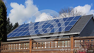 Solar Panels on a home in a neighborhood covering most of the roof Stock Photo