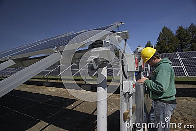 Solar panels inspected by workman Stock Photo