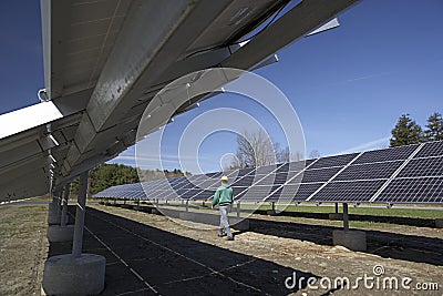 Solar panels inspected by workman Stock Photo