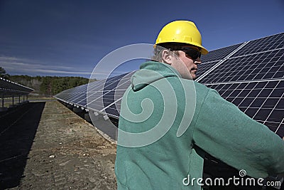 Solar panels inspected by workman Stock Photo