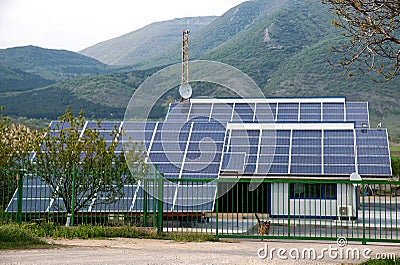 Solar panels, photovoltaics over the roof of an industrial building - alternative electricity source. Stock Photo