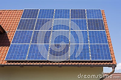 Solar Panels on the Red House Roof. Solar Energy Background. Stock Photo