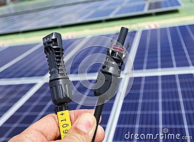 Solar PV Connectors Male and Female Hand Holding Stock Photo