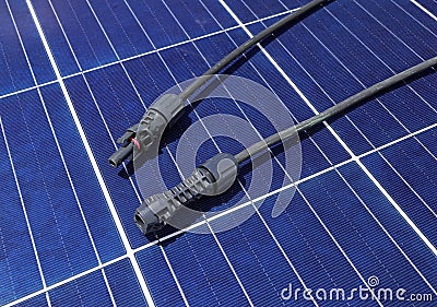 Solar PV Connectors Male and Female laid on Solar Panel Surface Stock Photo