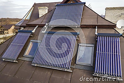 Solar water heating system on house roof. Hot water boiler, alternative ecological sun energy generator Stock Photo