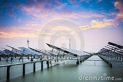 Solar and wind power in sunset Stock Photo