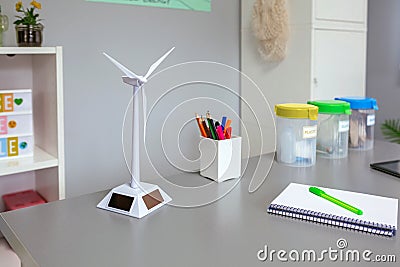 Solar windmill and selective trash bins over desk in classroom Stock Photo