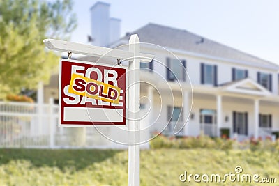 Sold Home For Sale Sign in Front of New House Stock Photo