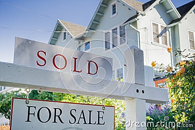 Sold sign in front of a house in a residential neighborhood Stock Photo