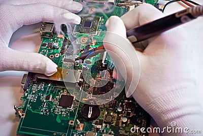 Soldering a circuit board in service laboratory. Stock Photo