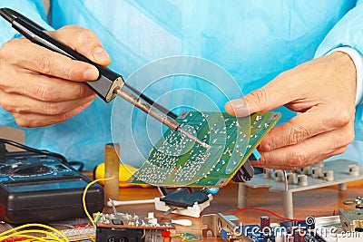 Soldering electronic board of device in service workshop Stock Photo