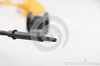 Soldering iron that is used a lot of times closeup view with empty roll of soldering wire on the background Stock Photo